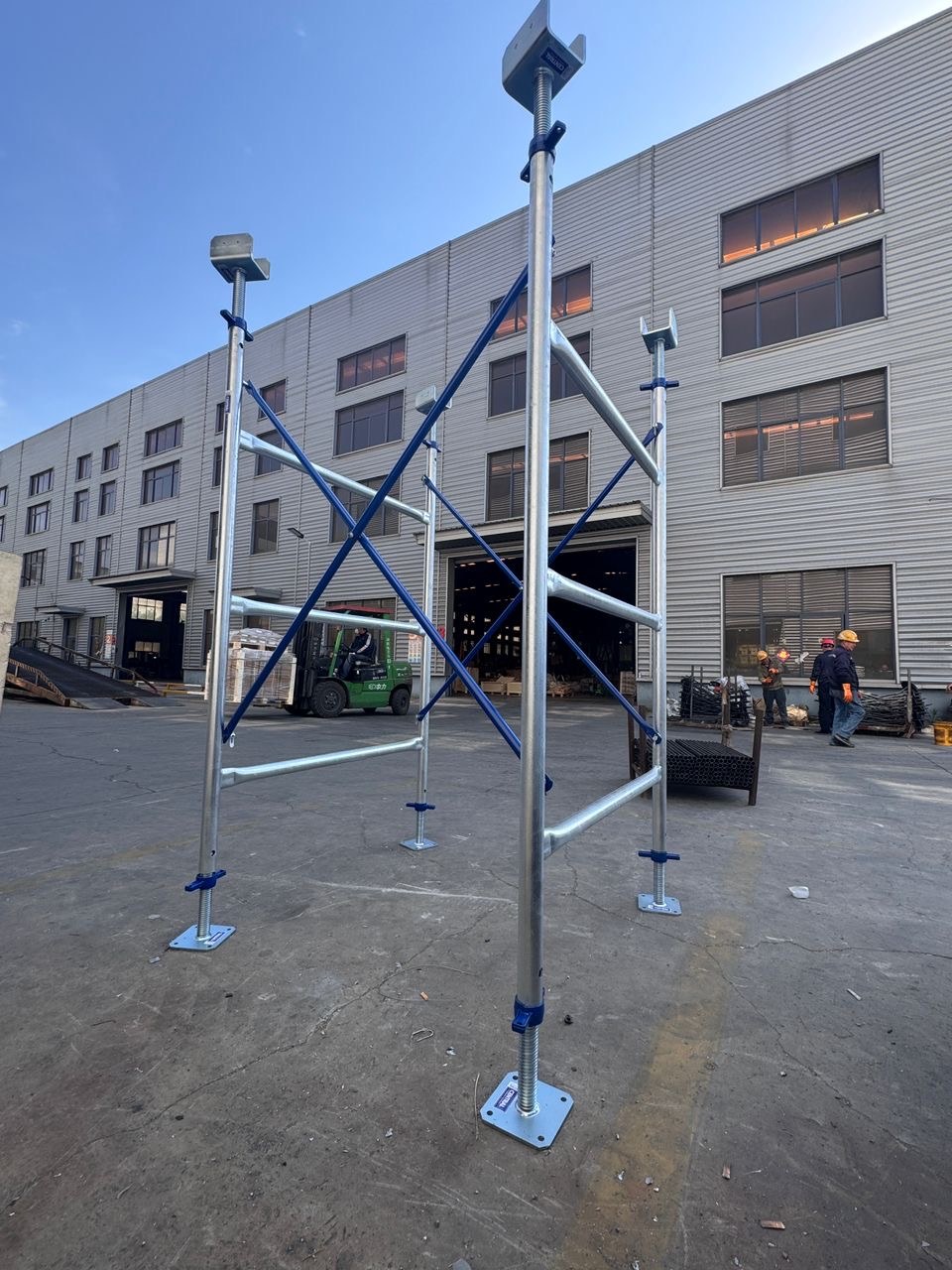 Central H Frame set assembled in the yard — frames, blue braces and jacks