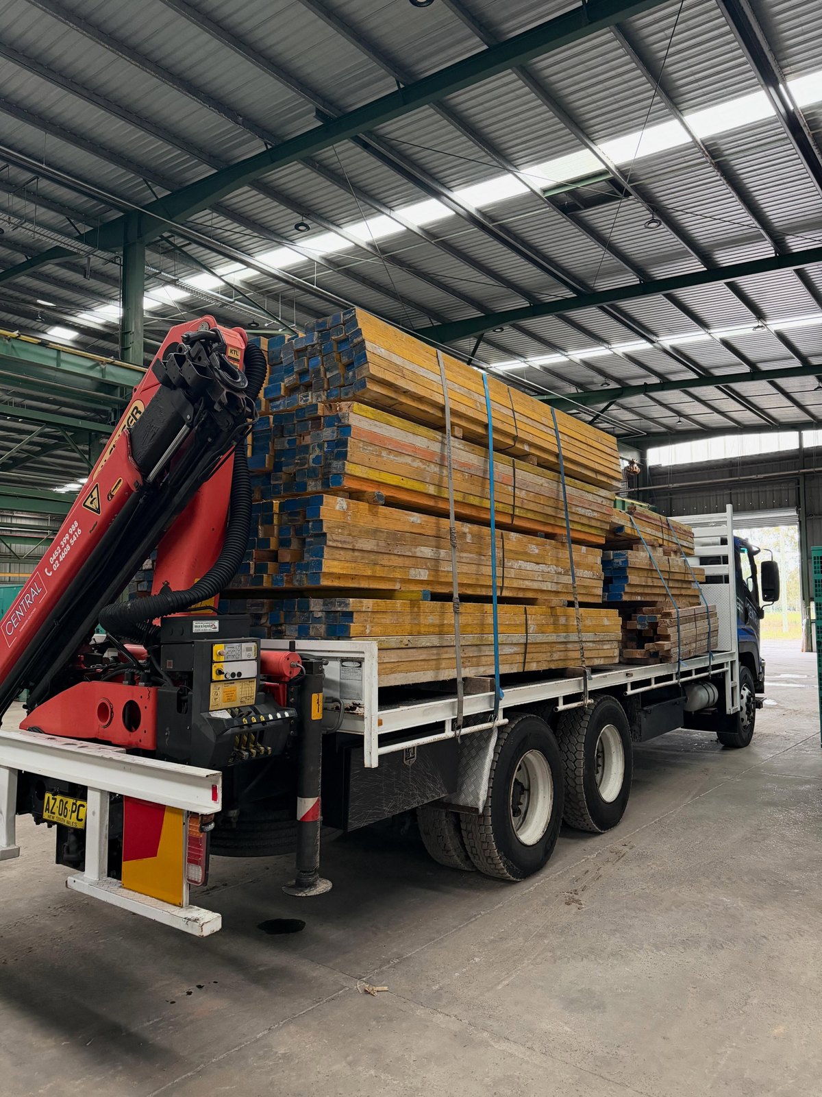 Central crane truck loaded with LVL and timber for site delivery